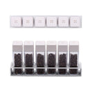 Top-down and front view of the Normcore Coffee Bean Cellars V2 Set of 6 in white, six tubes filled with roasted coffee beans in the stand
