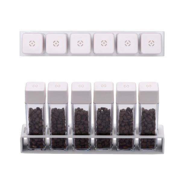 Top-down and front view of the Normcore Coffee Bean Cellars V2 Set of 6 in white, six tubes filled with roasted coffee beans in the stand