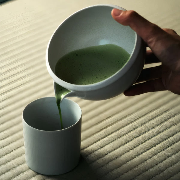 Pouring matcha from the Origami Katakuchi Matcha Bowl spout into a cup