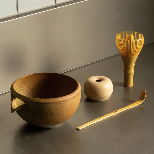 Origami Katakuchi Matcha Bowl in Wara Ochre on a bench